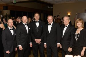 6 people posing for a photo at a black tie event