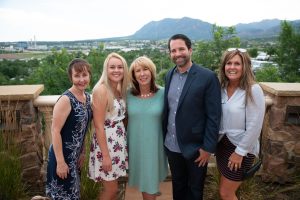 5 people standing for a picture on patio overlook